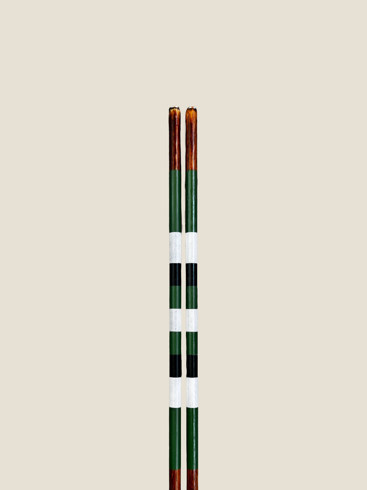 Close-up of the striped finish on Daintree hardwood golf alignment sticks.