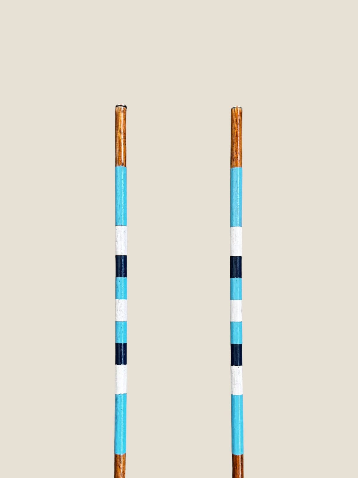 Surfers Paradise 45-inch stained hardwood golf alignment sticks, shown side by side.