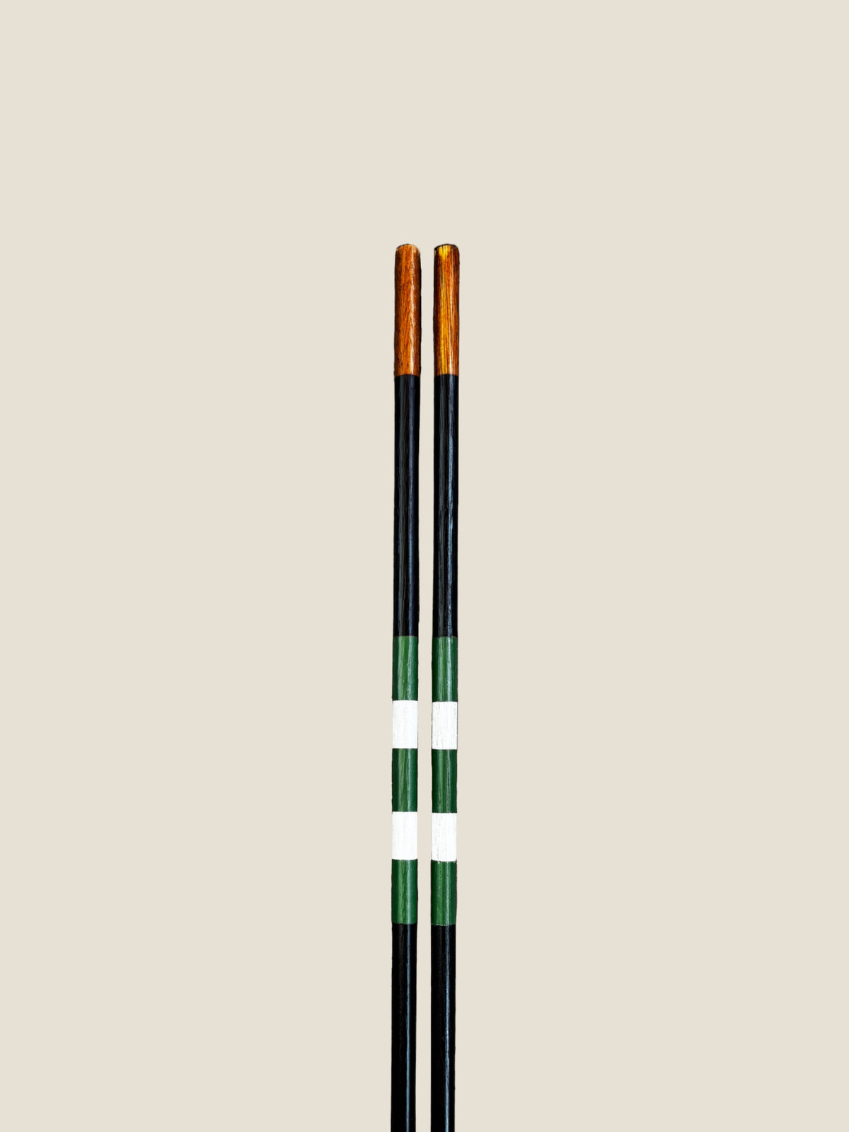 Close-up of the striped finish on Vineyard hardwood golf alignment sticks.